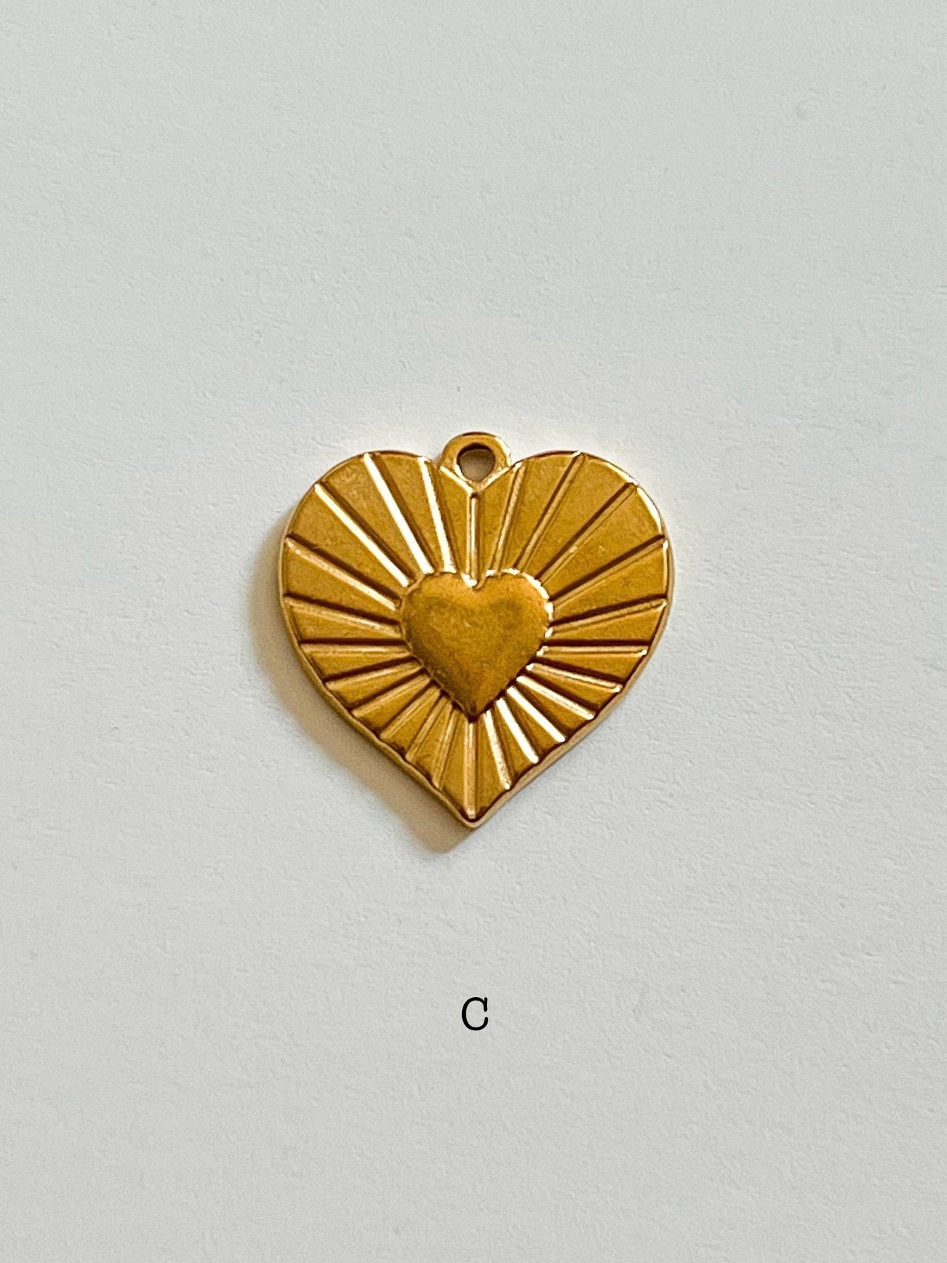 Sunburst heart charm